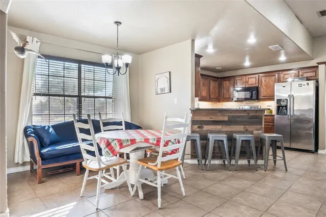 a dining area with furniture and window