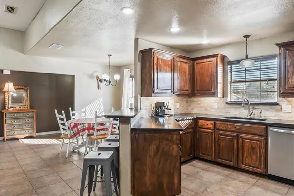 a kitchen with a sink stove and cabinets