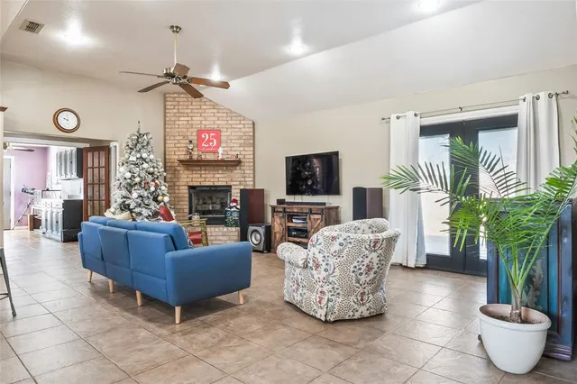 a living room with furniture a fireplace and a flat screen tv