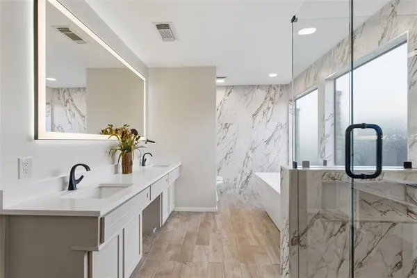 a bathroom with double vanity sink and mirror