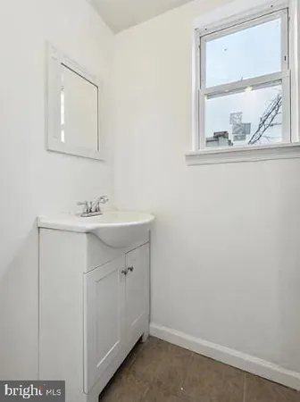 a bathroom with a sink mirror and cabinets