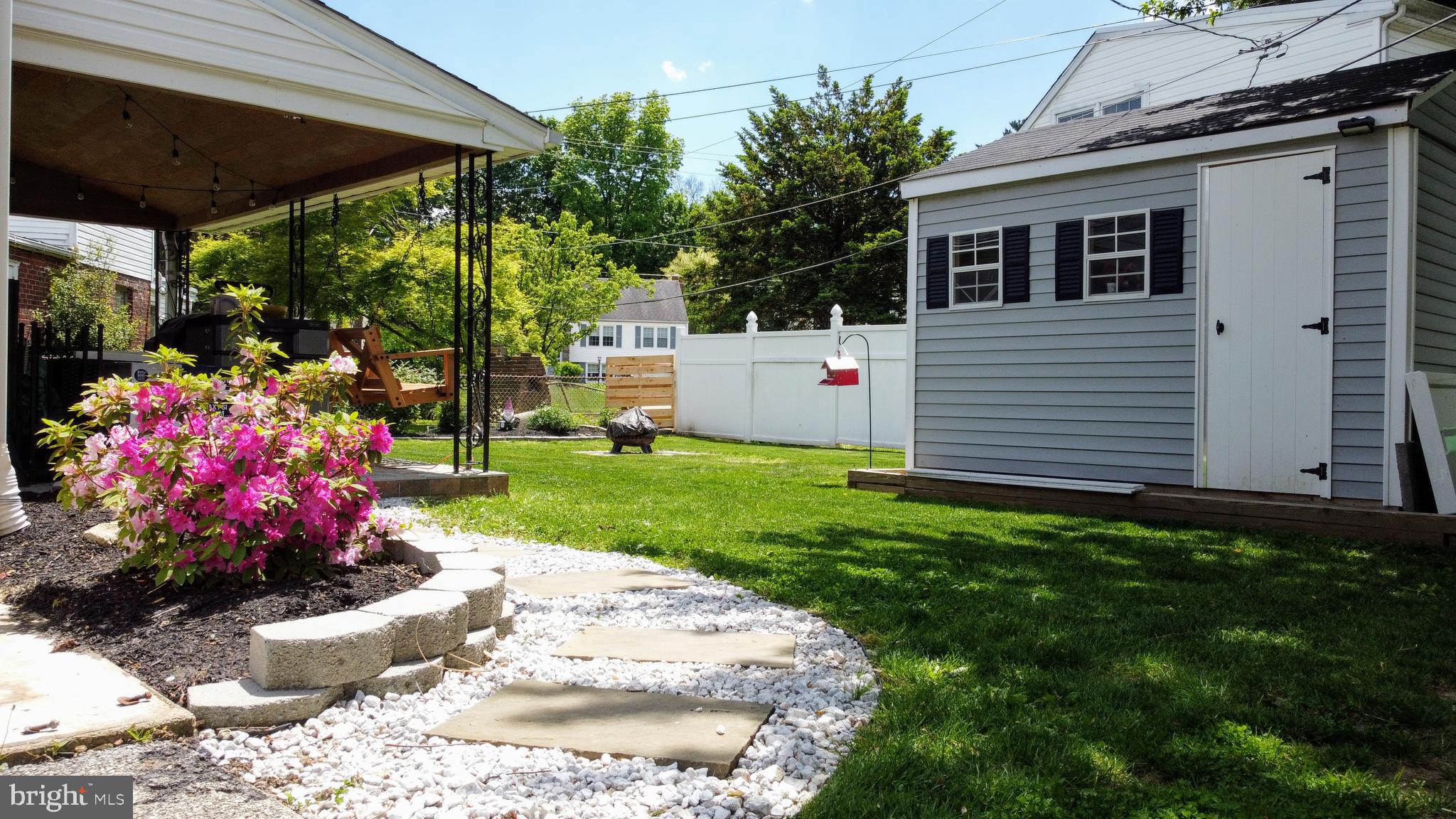 2212 Avon Road Ardmore, PA 19003 - Photo 2 of 23 a front view of a house with a yard fountain and a porch