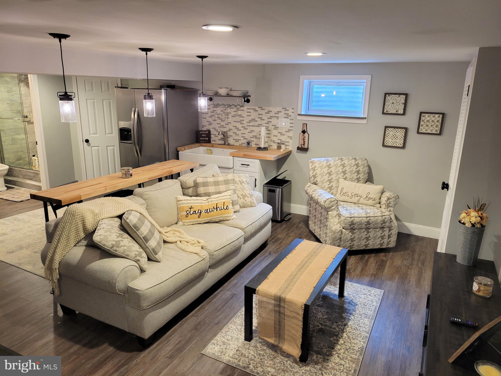 2212 Avon Road Ardmore, PA 19003 - Photo 14 of 23 a living room with furniture and a chandelier