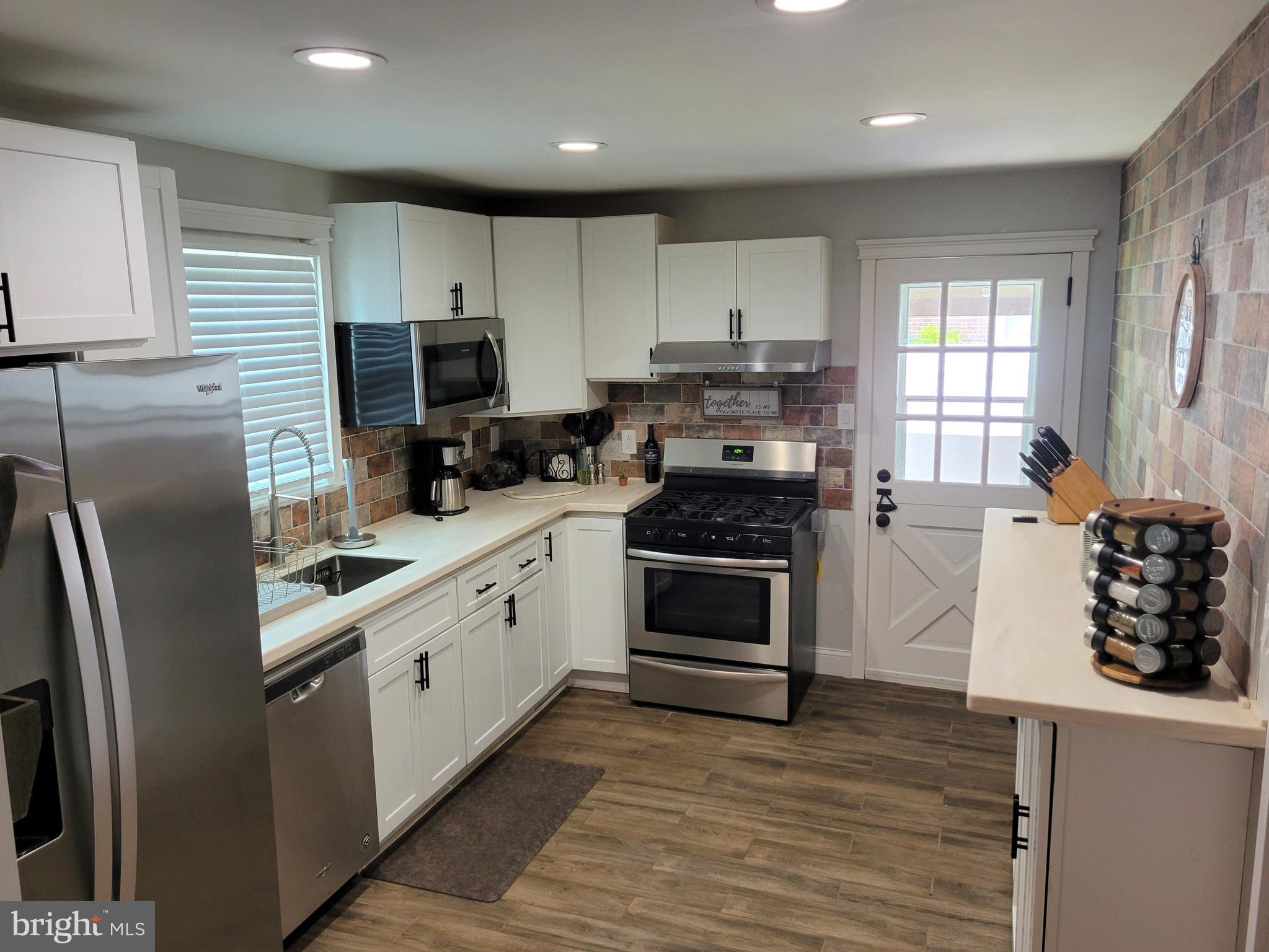 2212 Avon Road Ardmore, PA 19003 - Photo 8 of 23 a kitchen with stainless steel appliances a refrigerator sink and cabinets