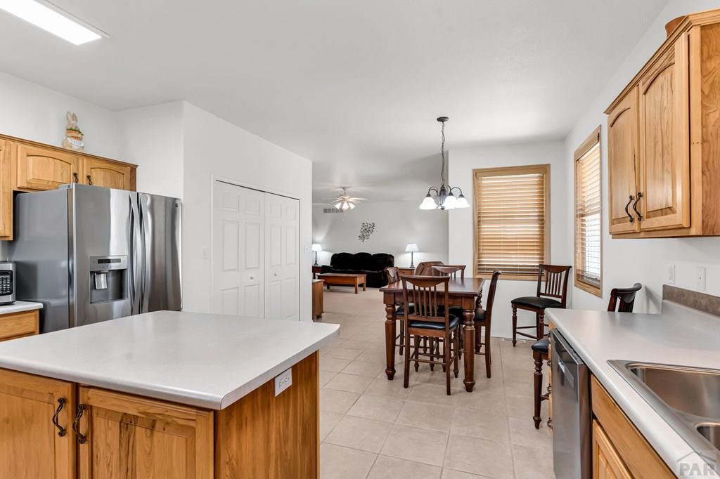 2064 Iris Road Pueblo, CO 81006 - Photo 12 of 56 a kitchen with lots of counter top space and dining table