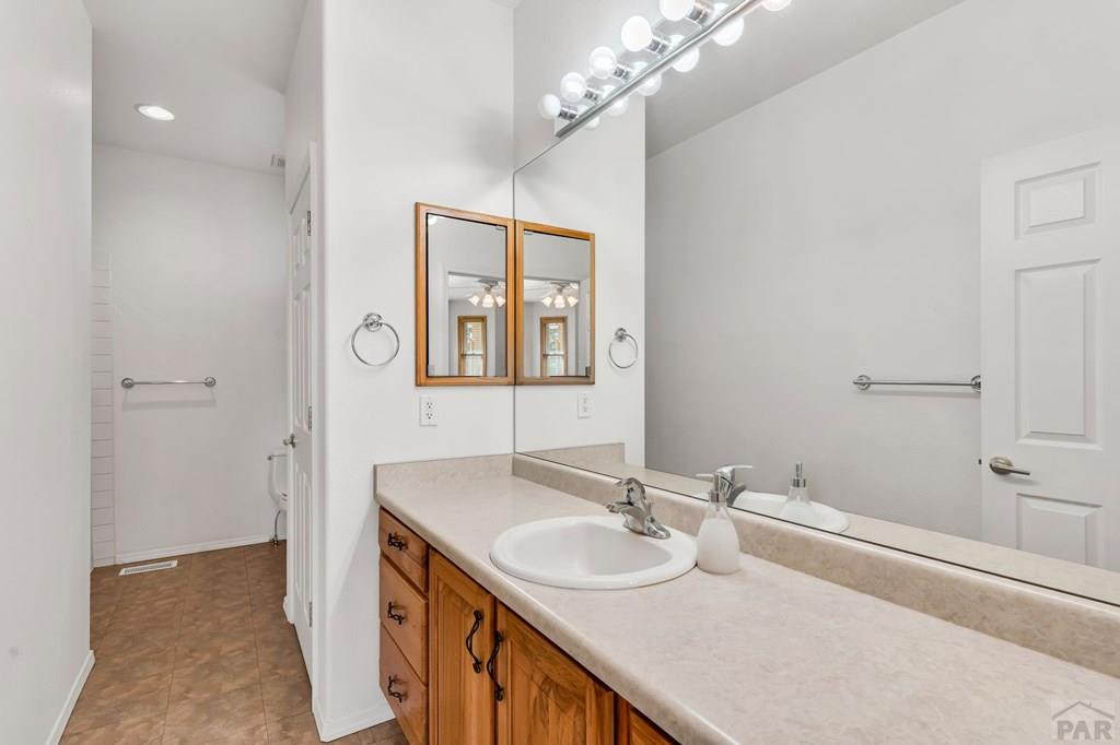 2064 Iris Road Pueblo, CO 81006 - Photo 17 of 56 a bathroom with a sink double vanity and a mirror