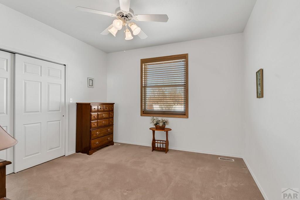 2064 Iris Road Pueblo, CO 81006 - Photo 19 of 56 an empty room with windows and fan