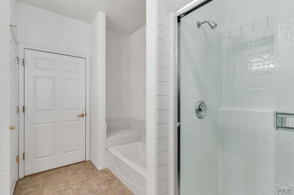 2064 Iris Road Pueblo, CO 81006 - Photo 22 of 56 a bathroom with a bathtub and shower