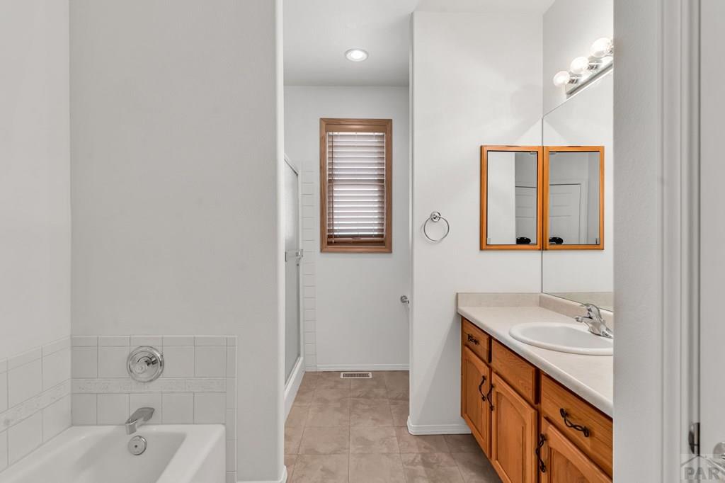2064 Iris Road Pueblo, CO 81006 - Photo 23 of 56 a bathroom with a sink and a mirror