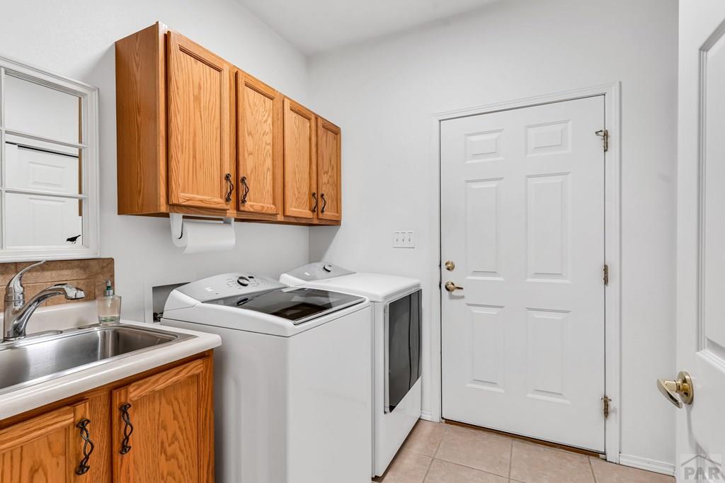 2064 Iris Road Pueblo, CO 81006 - Photo 24 of 56 a kitchen with a sink cabinets and appliances