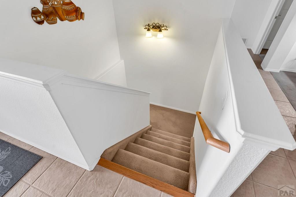 2064 Iris Road Pueblo, CO 81006 - Photo 25 of 56 a view of staircase with white walls