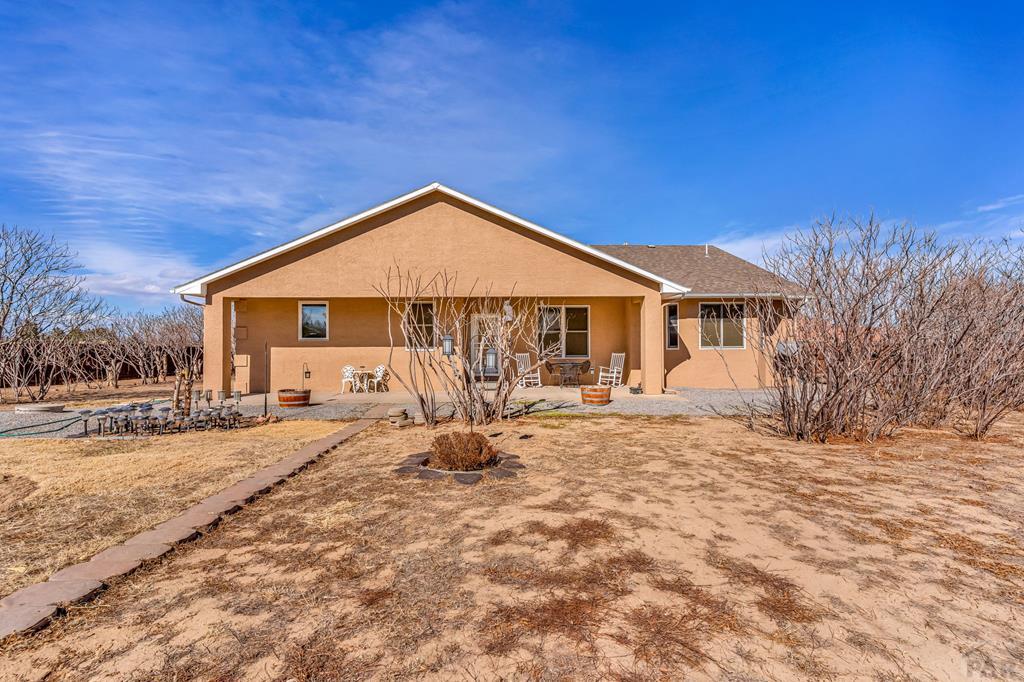 2064 Iris Road Pueblo, CO 81006 - Photo 32 of 56 a house with trees in the background