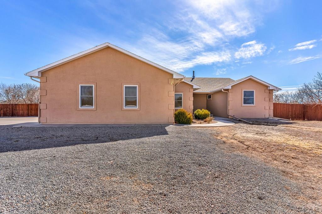 2064 Iris Road Pueblo, CO 81006 - Photo 37 of 56 a view of a house with backyard and trees