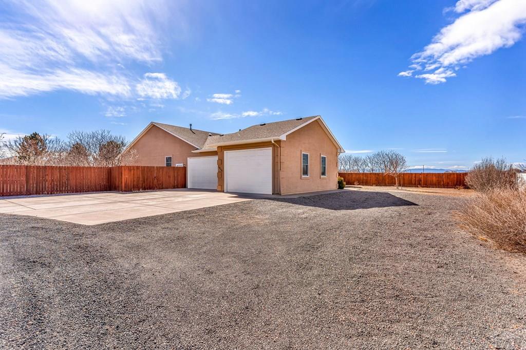 2064 Iris Road Pueblo, CO 81006 - Photo 39 of 56 a view of an house with backyard and bushes