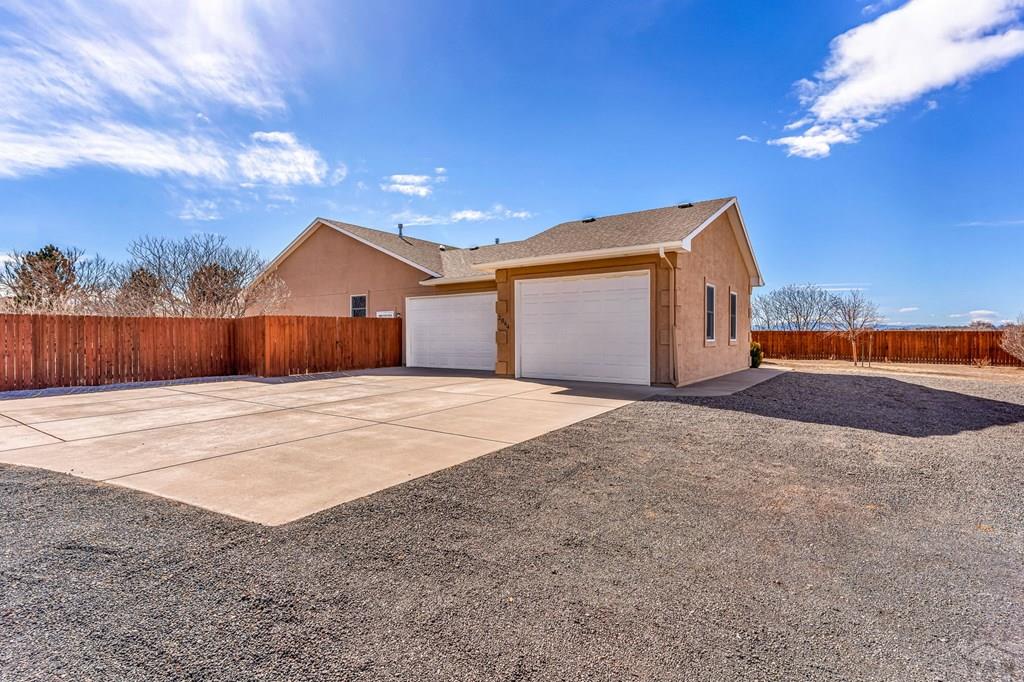 2064 Iris Road Pueblo, CO 81006 - Photo 40 of 56 a front view of a house with a yard