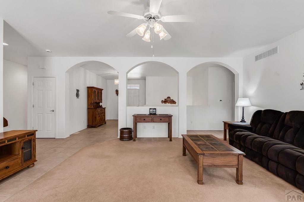 2064 Iris Road Pueblo, CO 81006 - Photo 4 of 56 a living room with furniture and a chandelier