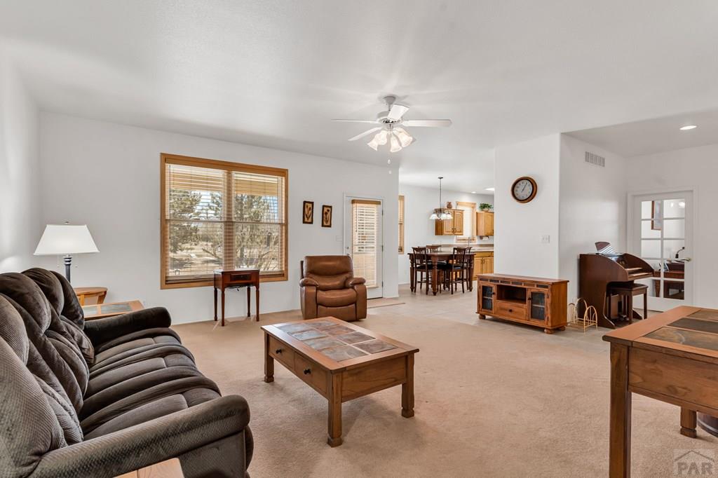 2064 Iris Road Pueblo, CO 81006 - Photo 6 of 56 a living room with furniture and a large window