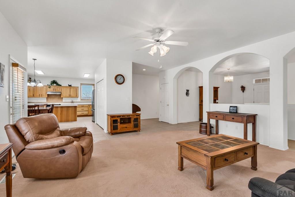 2064 Iris Road Pueblo, CO 81006 - Photo 7 of 56 a living room with furniture a table and kitchen view