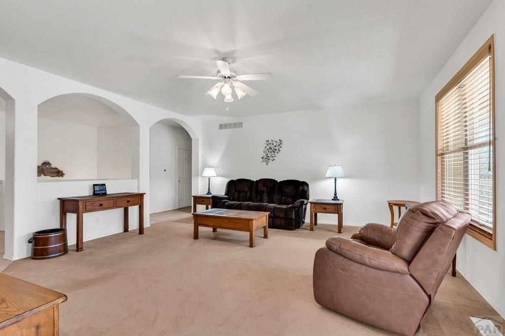 2064 Iris Road Pueblo, CO 81006 - Photo 8 of 56 a living room with furniture a table and a large window