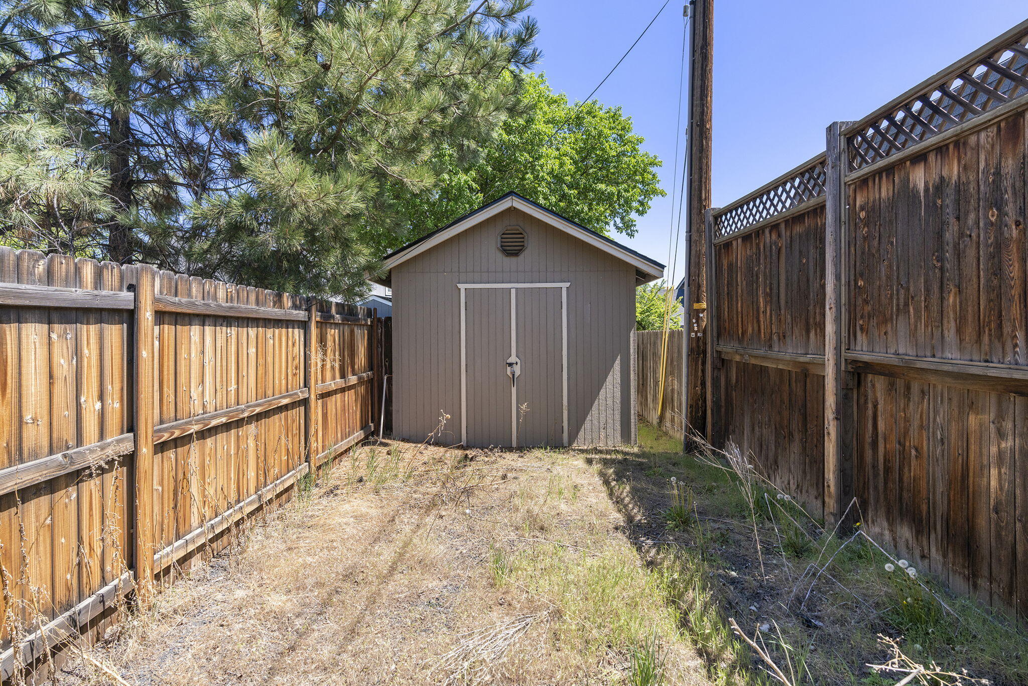 2211 Southwest Quartz Avenue Redmond, OR 97756 - Photo 19 of 26 a view of a small barn with wooden fence