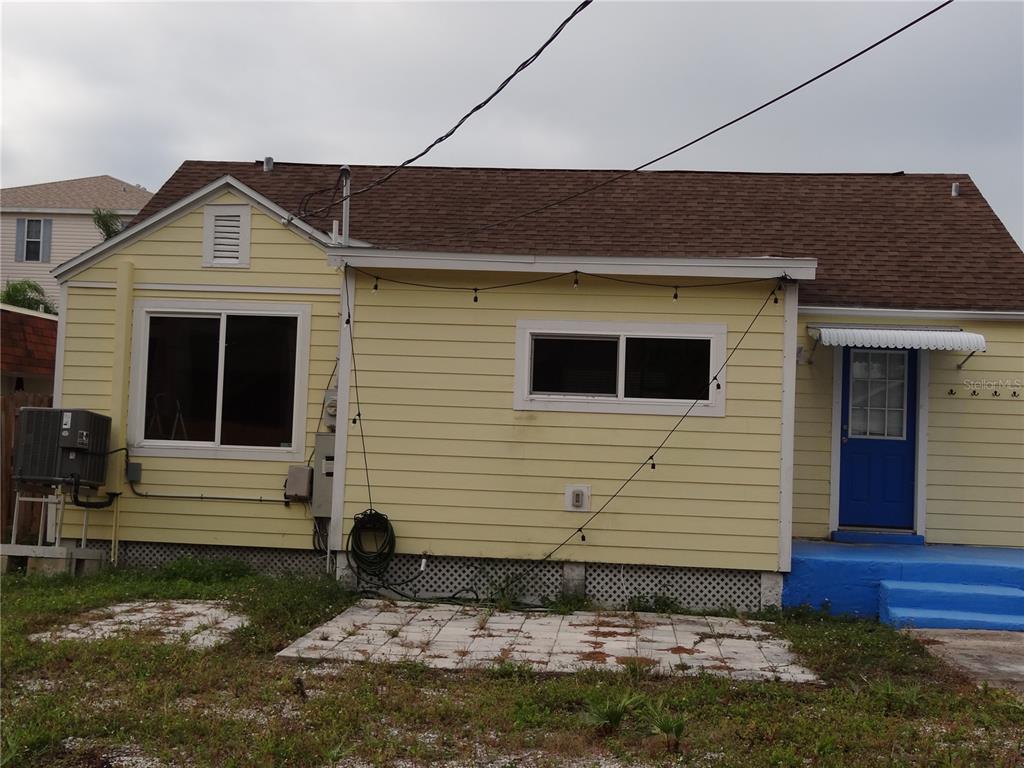 14117 Palm Street Madeira Beach, FL 33708 - Photo 2 of 25 a front view of a house with a yard