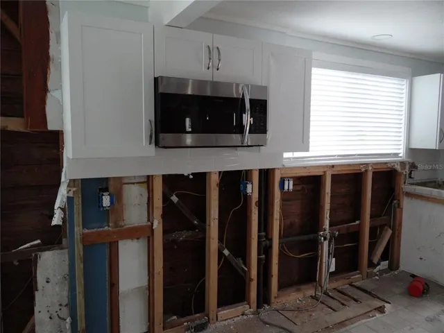 a kitchen with a microwave and a sink