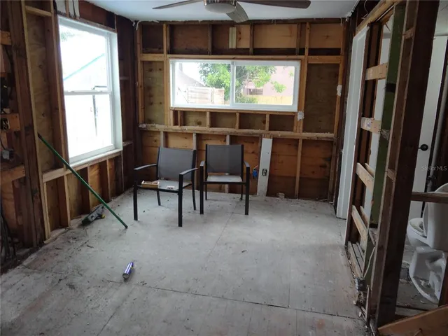 a view of a room with furniture and a window