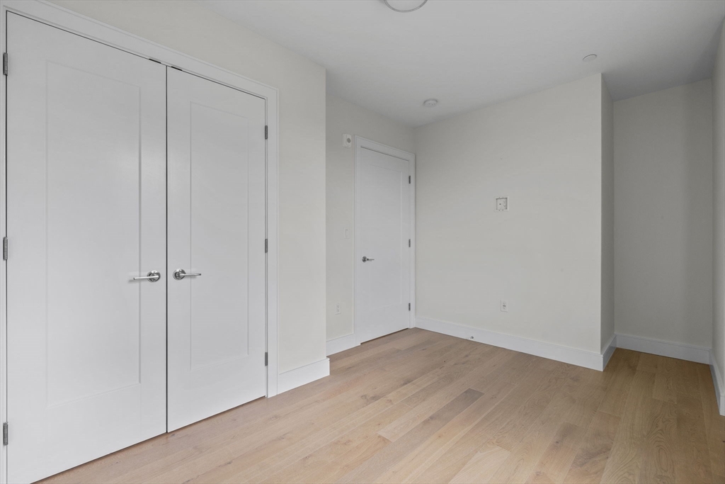 301 Border Street, Unit 411 Boston, MA 02128 - Photo 11 of 14 a view of room with hardwood floor