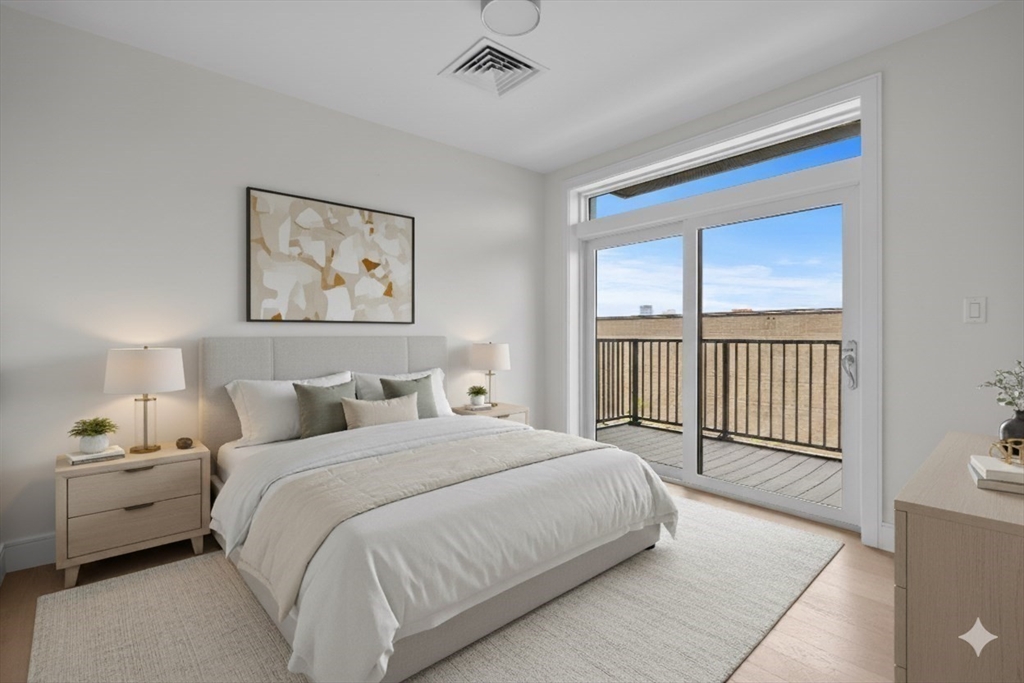 301 Border Street, Unit 411 Boston, MA 02128 - Photo 3 of 14 a bedroom with a large bed and a window