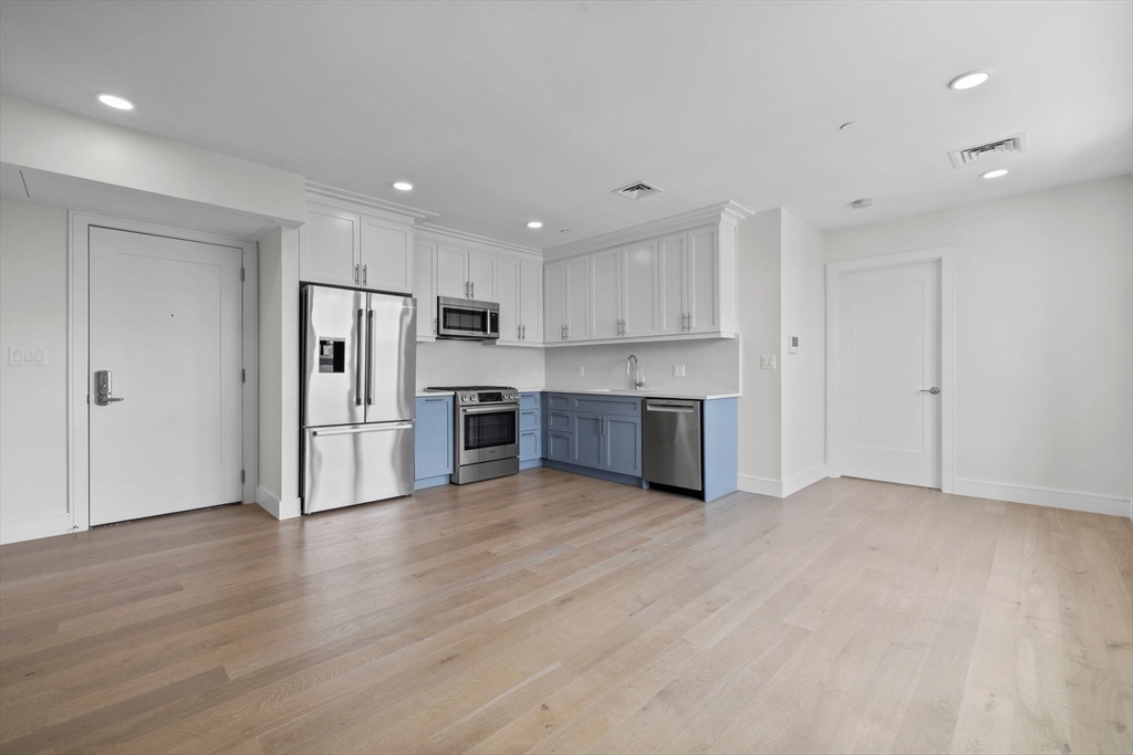 301 Border Street, Unit 411 Boston, MA 02128 - Photo 7 of 14 a kitchen with stainless steel appliances a refrigerator and a oven