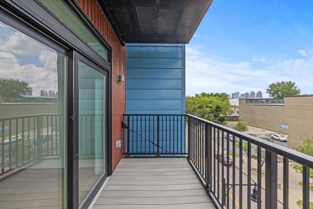 301 Border Street, Unit 411 Boston, MA 02128 - Photo 10 of 14 a view of a balcony with wooden floor and city view