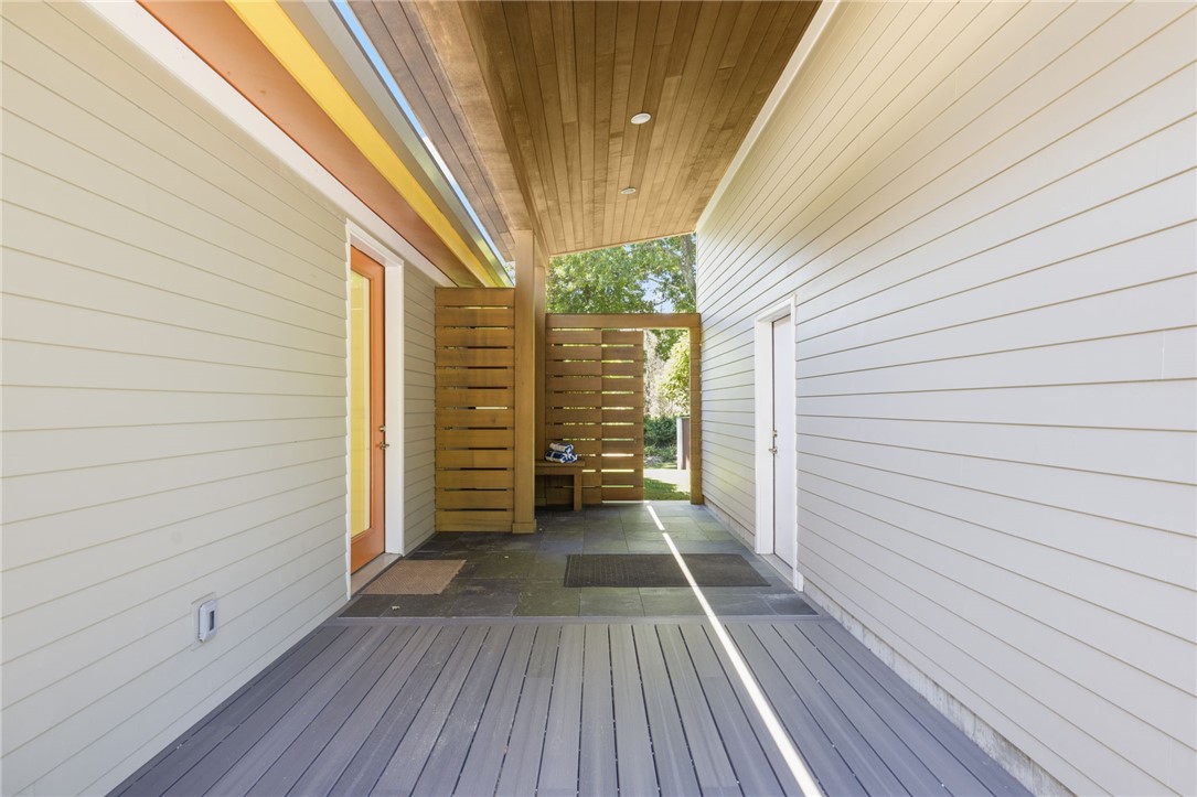 621 East Shore Road Jamestown, RI 02835 - Photo 10 of 50 This cedar covered breezeway has an outdoor shower and connects to the oversized two car garage, with an additional entry into the home.