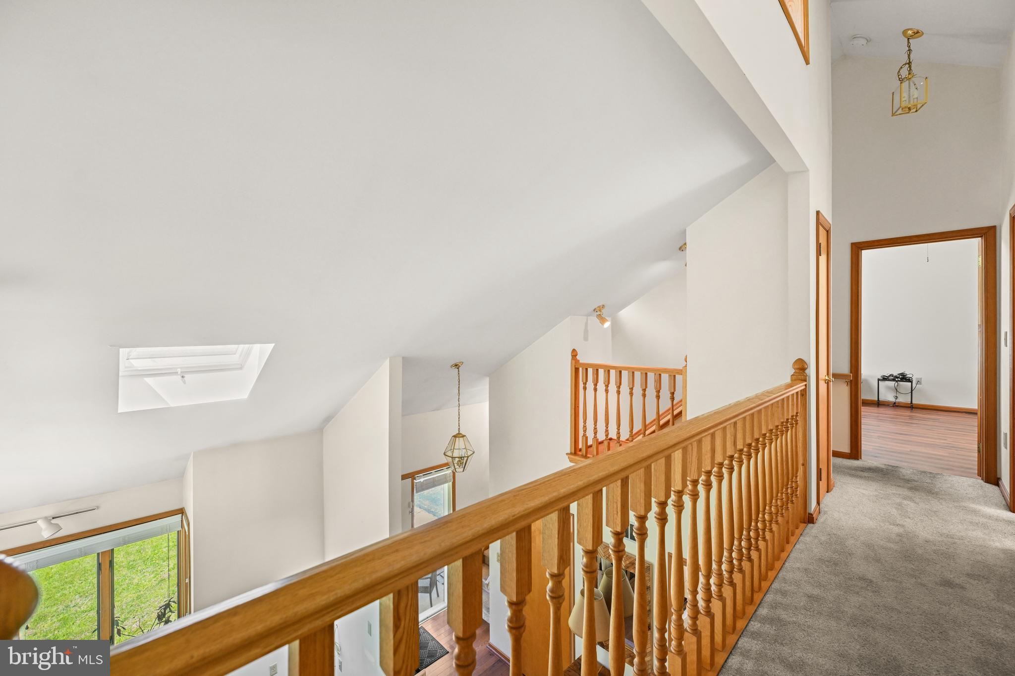 1680 East Street Road Kennett Square, PA 19348 - Photo 15 of 30 a view of staircase with lots of frames on wall and windows
