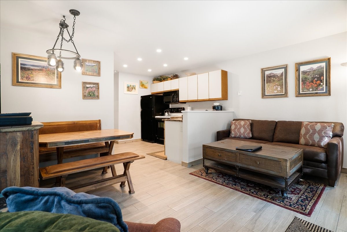 120 Sawmill Road, Unit 106 Breckenridge, CO 80424 - Photo 3 of 25 a living room with furniture and a wooden floor