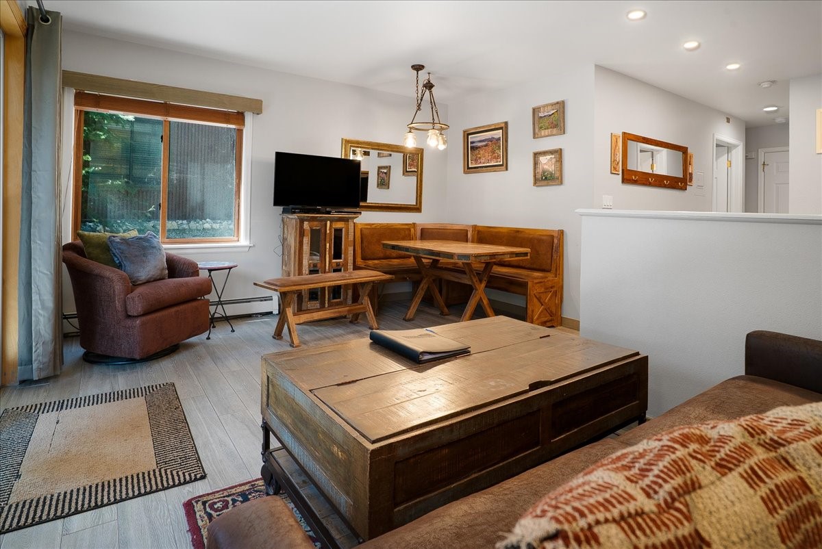 120 Sawmill Road, Unit 106 Breckenridge, CO 80424 - Photo 6 of 25 a living room with furniture and a flat screen tv