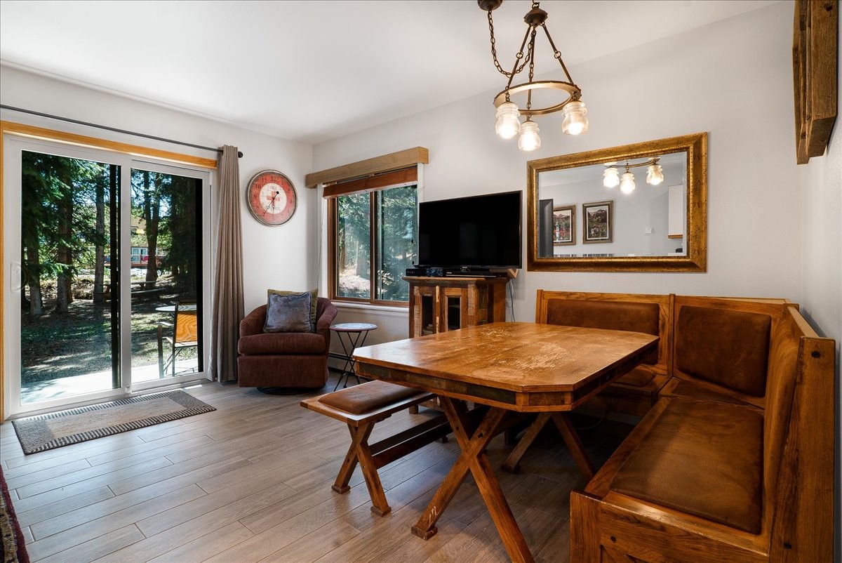 120 Sawmill Road, Unit 106 Breckenridge, CO 80424 - Photo 8 of 25 a living room with furniture a flat screen tv and a floor to ceiling window