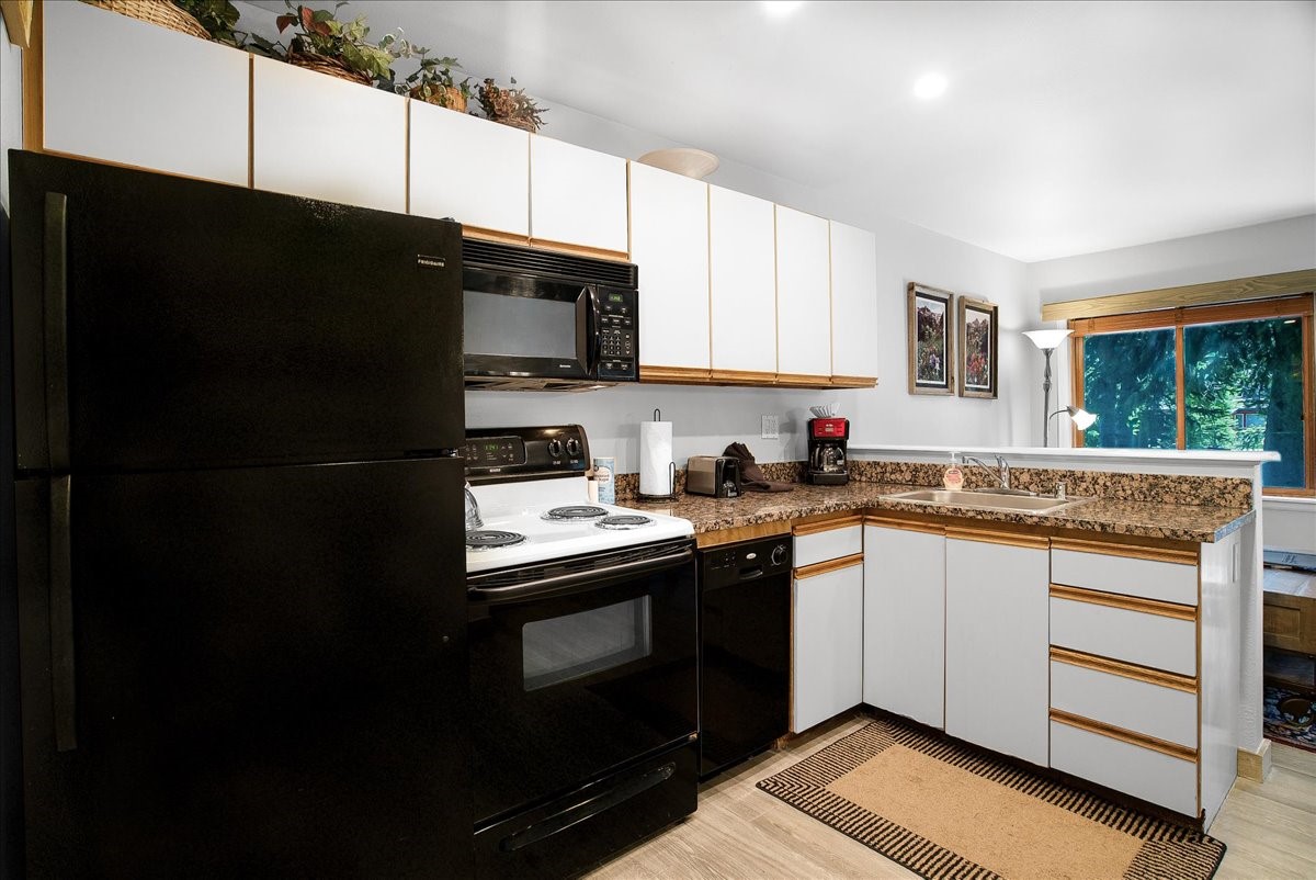 120 Sawmill Road, Unit 106 Breckenridge, CO 80424 - Photo 10 of 25 a kitchen with granite countertop a refrigerator stove and sink