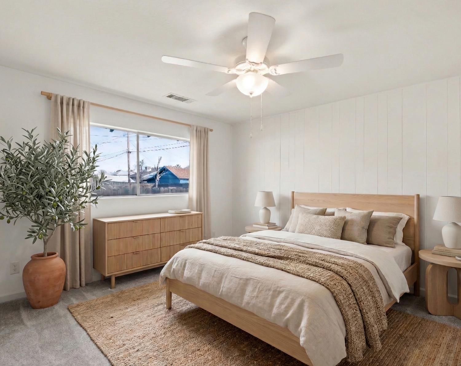 425 West Elm Street Hanford, CA 93230 - Photo 14 of 18 a bedroom with a bed and a chandelier