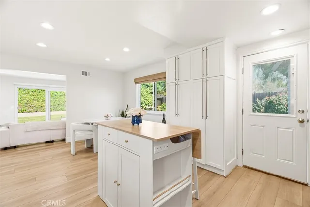 a view of a kitchen counter space wooden floor and windows