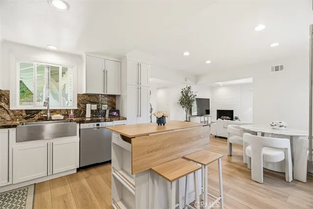 a large kitchen with a table and chairs in it