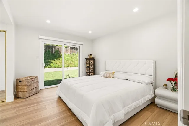 a bedroom with a large bed and a window