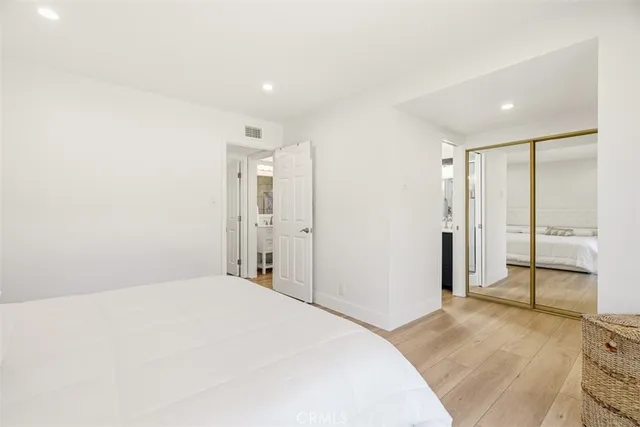 a spacious bedroom with a bed and a shower