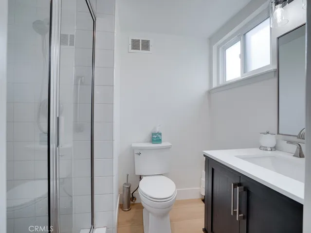 a bathroom with a toilet a sink and a window