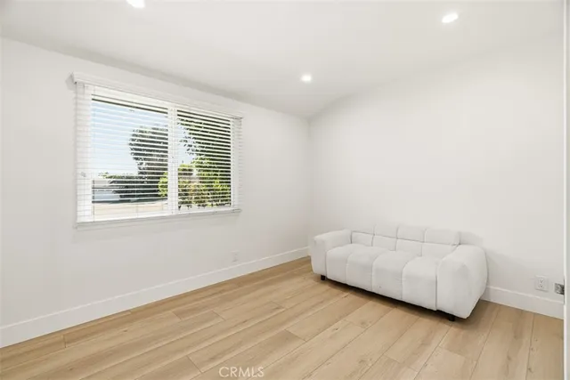 a view of a room with wooden floor and a window
