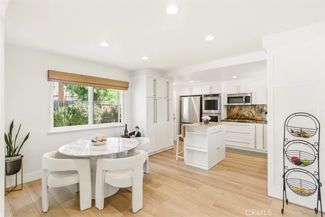 a kitchen with a table and chairs