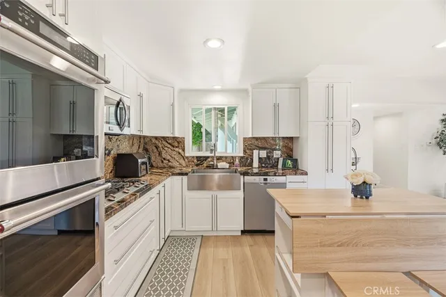 a kitchen with a sink stove and refrigerator