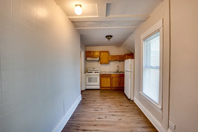 a view of a kitchen with a stove top oven