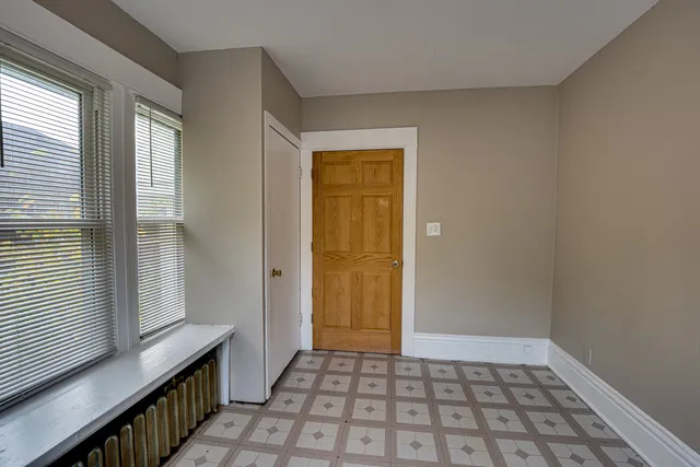 a view of a hallway with wooden floor and windows