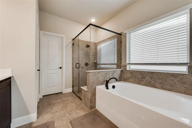a bathroom with a bathtub and a shower