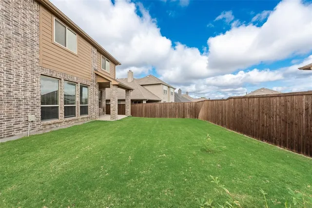 a view of an house with backyard and porch